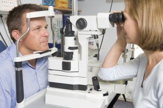 Bigstock_ 58477976 - Optometrist In Exam Room With Man In Chair.jpg