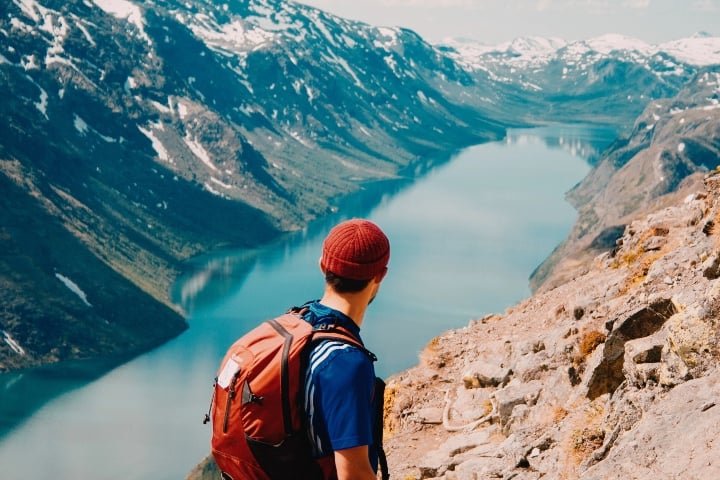 Man hiking over canyon with river