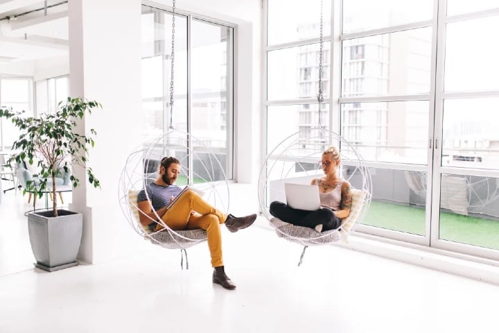 employees sitting in chair pods working