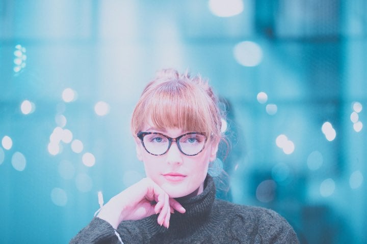 Young adult woman in glasses and turtleneck